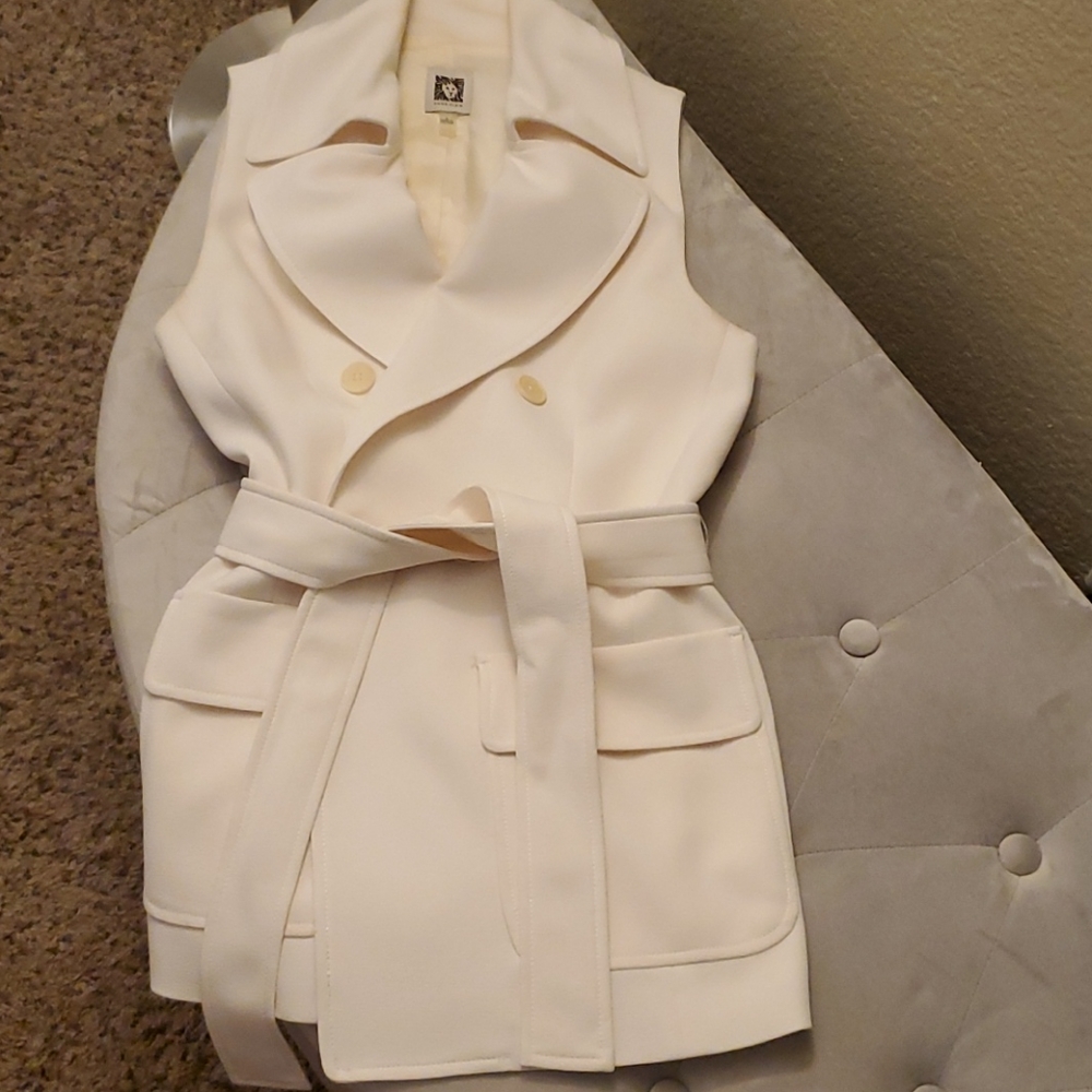 Cream sleeveless suit jacket with tie belt